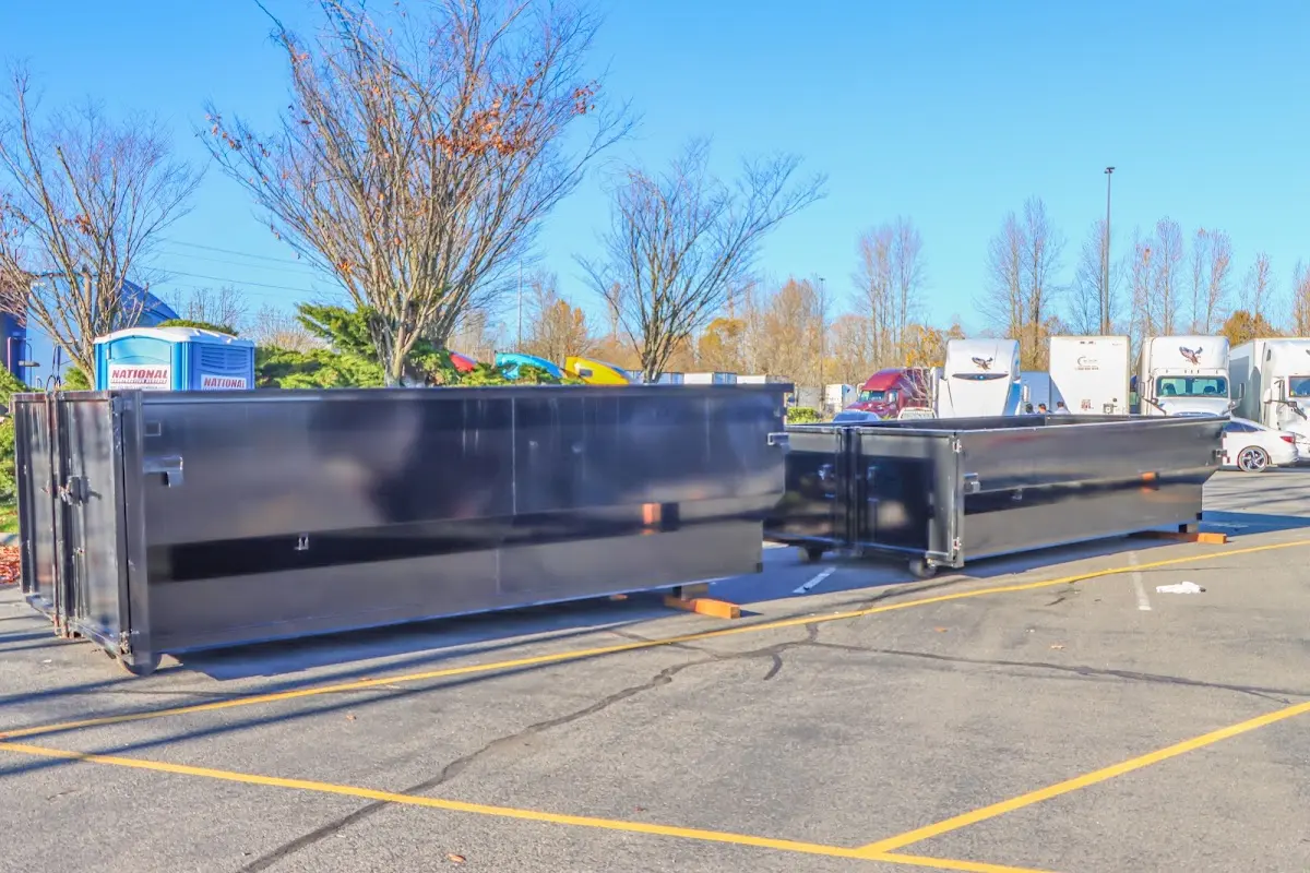 Professional dumpster rental service with roll-off container on residential driveway in Holbrook